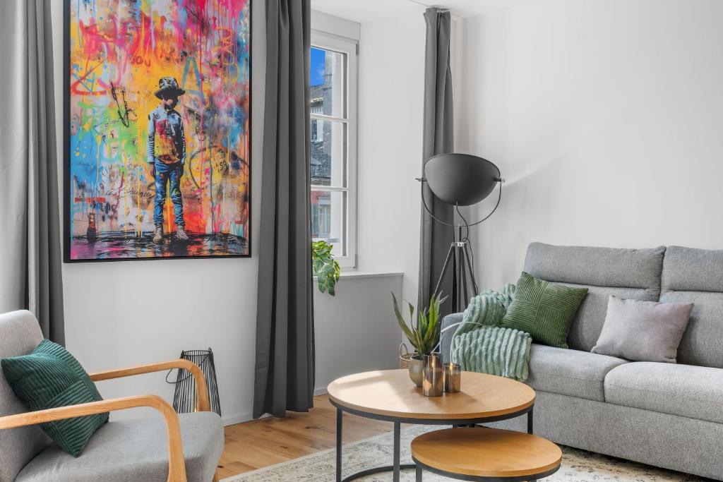a living room with a couch and a table at Chez Fridolin in Glarus