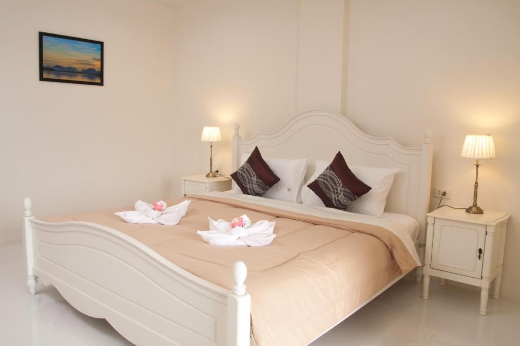 Postel nebo postele na pokoji v ubytování JS Residence Krabi