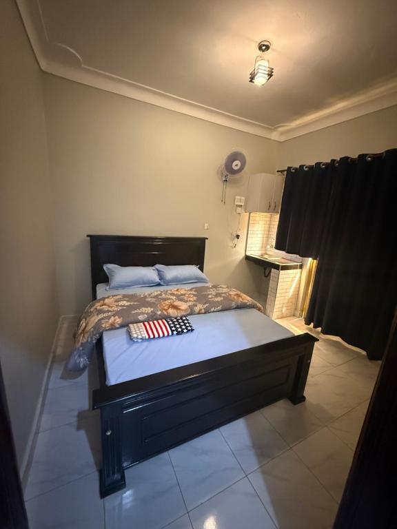 a bedroom with a bed with an american flag on it at Crown Motel Lugala in Kampala