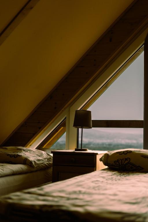 a bedroom with two beds and a window at Domek Panorama in Lipowa