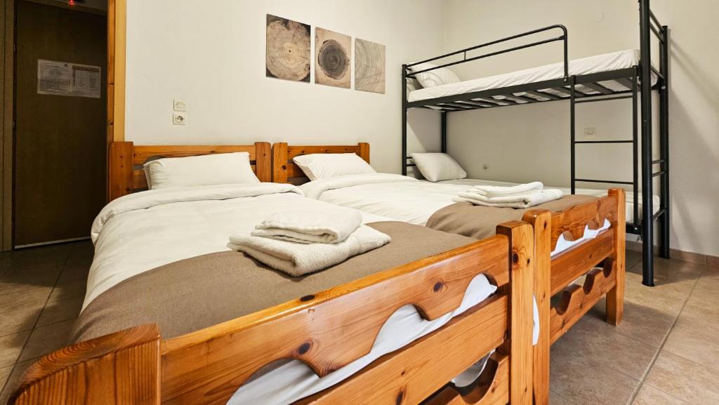 two beds in a room with a bunk bed at Elation Rooms in Elatochori