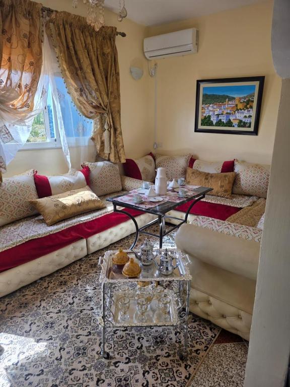 a living room with a couch and a table at Desert Stars Oasis in Aoufous