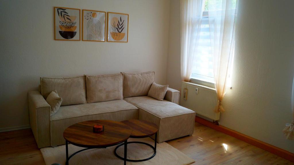 a living room with a couch and a table at Apartment 24 modern & gemütlich in Dessau
