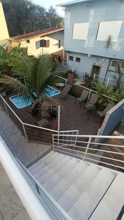 an outdoor stairway with chairs and trees and a building at Studio Home 4 in Jacareí