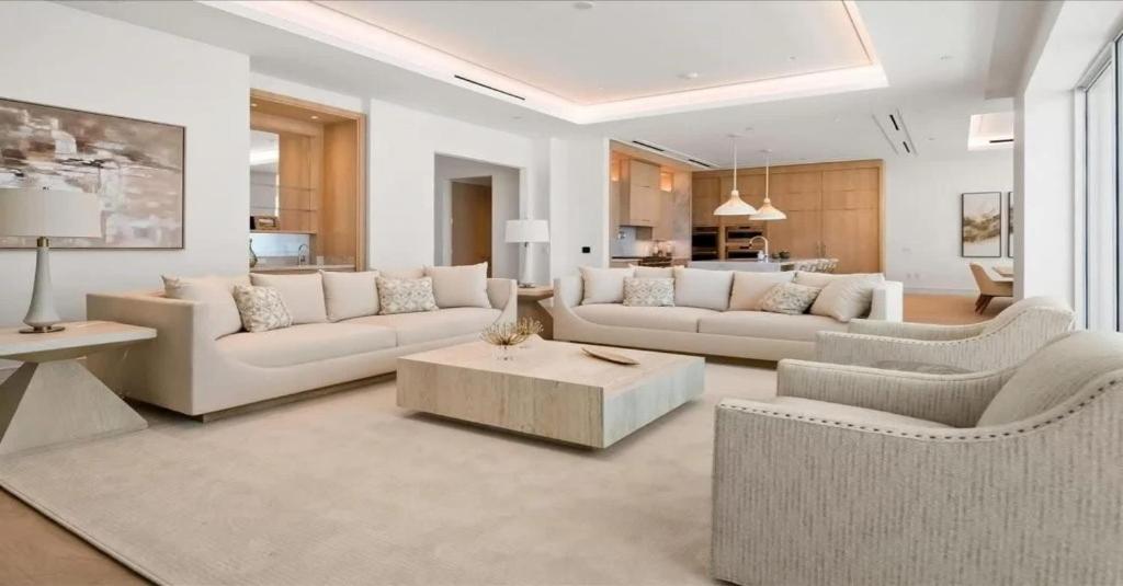 a living room with two couches and a table at Naples Luxury Retreat in Naples