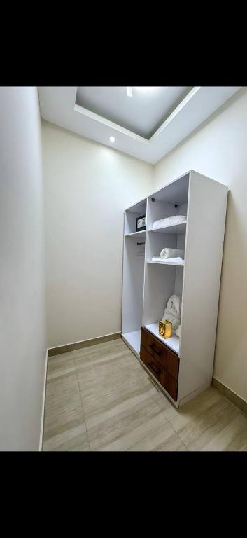 a room with an empty refrigerator in a room at Garden C Hotel Nile Plaza in Cairo