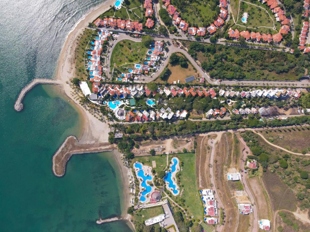 an aerial view of a resort next to the water at Quiya Beach Residences in Cruz de Huanacaxtle