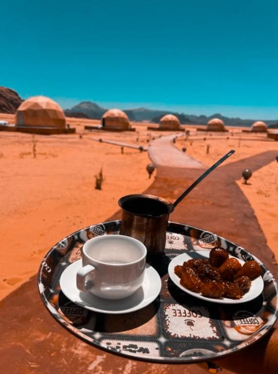 a plate of food on a table in the desert at camp sand in Disah