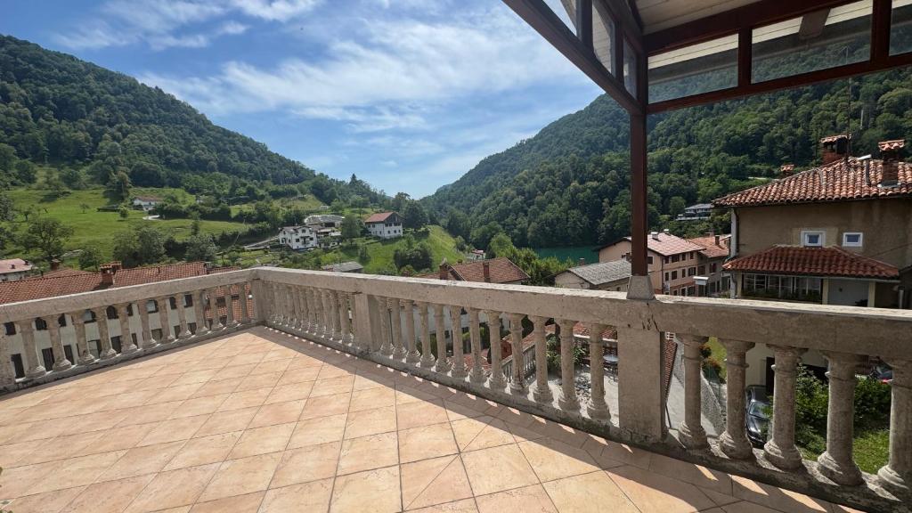 a balcony with a view of a valley and mountains at Stylish Penthouse with large terrace in Most na Soči