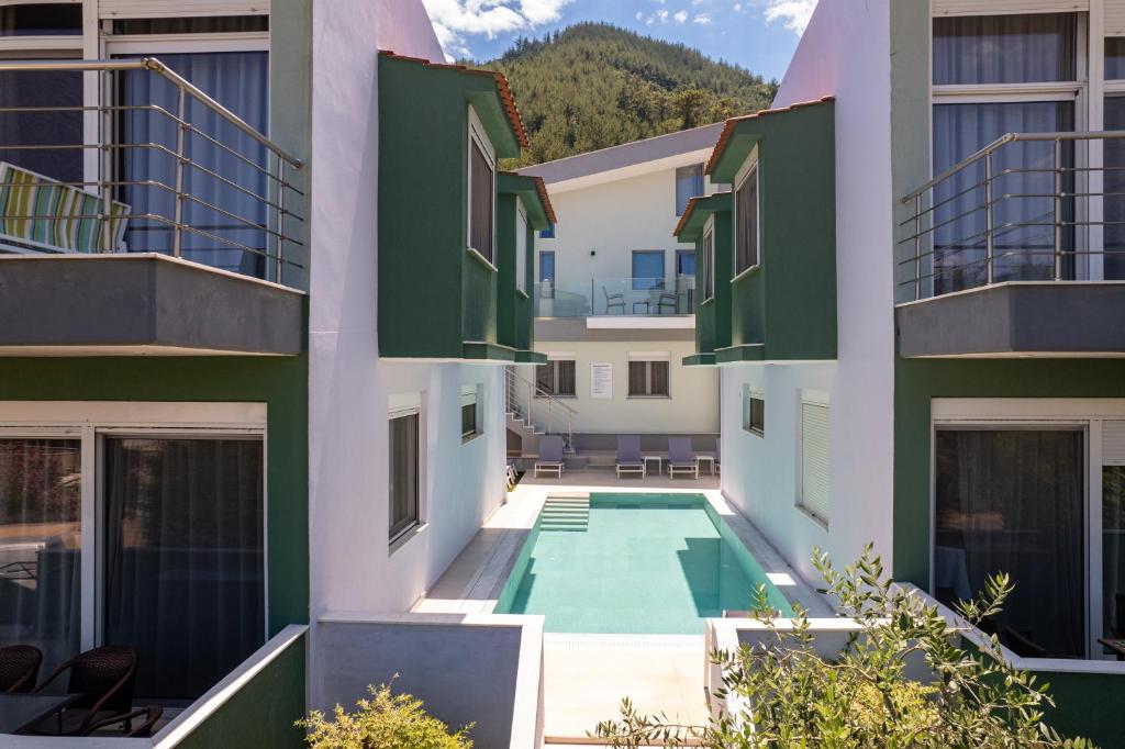 an apartment complex with a swimming pool between two buildings at Verde Villas in Skala Potamias