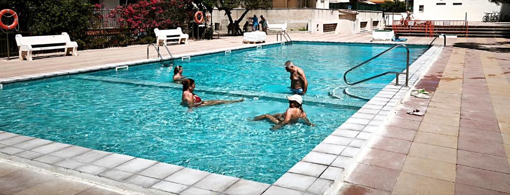 a group of men playing in a swimming pool at CALAFELL 5 BEACH in Calafell