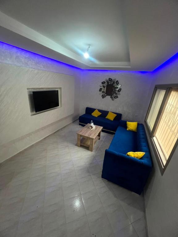 a living room with a couch and a tv at la perle d'el jadida in El Jadida