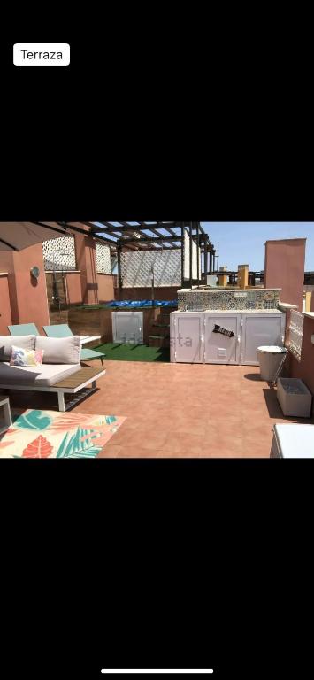 a picture of a patio with a grill and tables at Vera dream Las Marinas LAGUNA BEACH in Vera