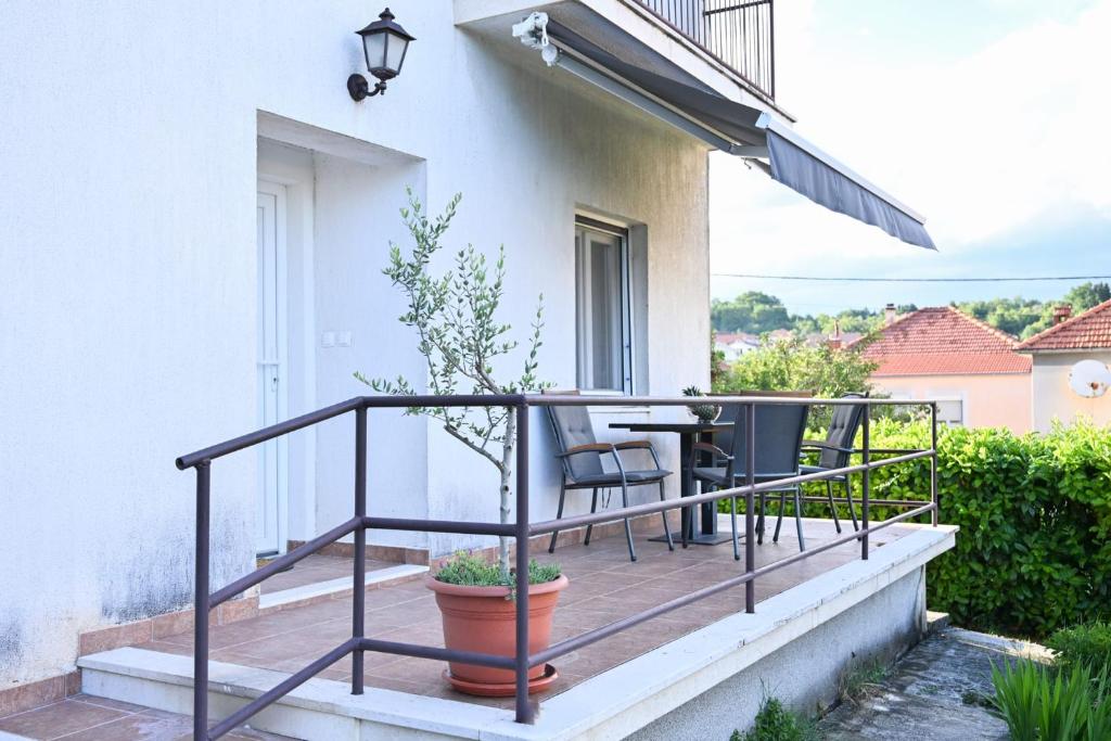 a balcony with a table and chairs on a house at Brko's Place Sinj in Sinj
