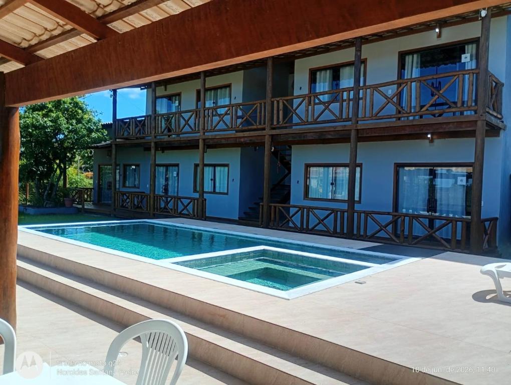 a swimming pool in front of a building at Via Del Mare Flats in Marau