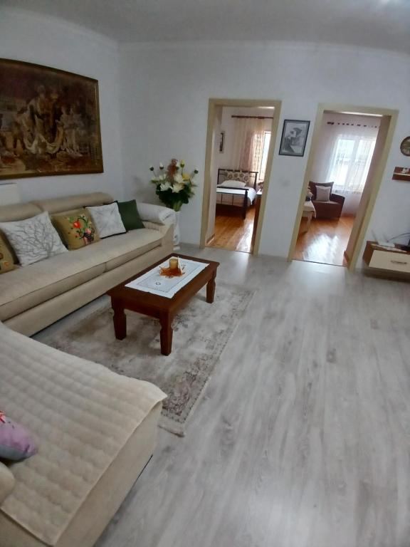 a living room with a couch and a coffee table at EniGuesthouse in Gjirokastër