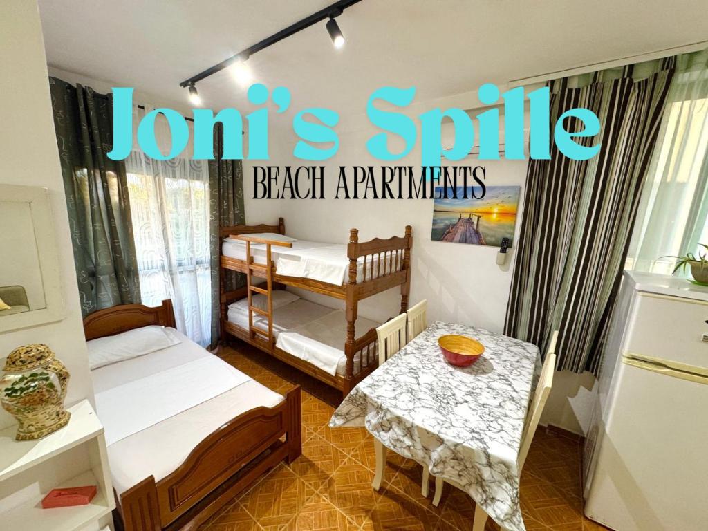 a small room with two beds and a table at Joni's Beach Apartments - Spille in Spille