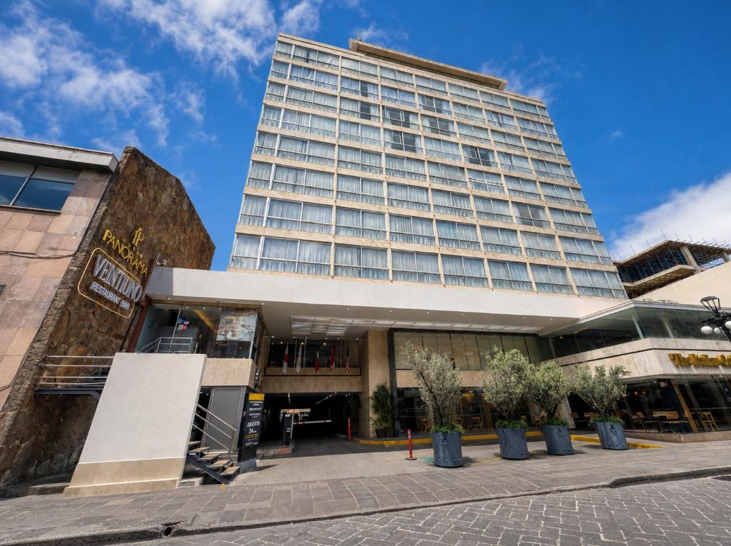 a tall building with trees in front of it at Panorama in San Luis Potosí