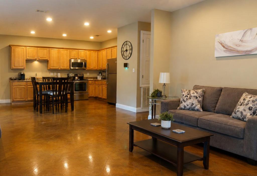 a living room with a couch and a table at Ground Floor, 3BR Sleeps 8, Near Ingalls and Chevron -F- in Moss Point