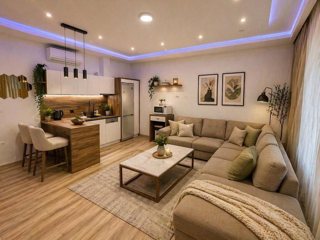 a living room with a couch and a table and a kitchen at Apartment Music in Sarajevo