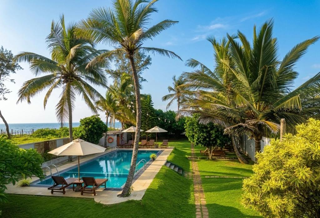 an image of a resort with a swimming pool and palm trees at Ziegler Cottage in Negombo