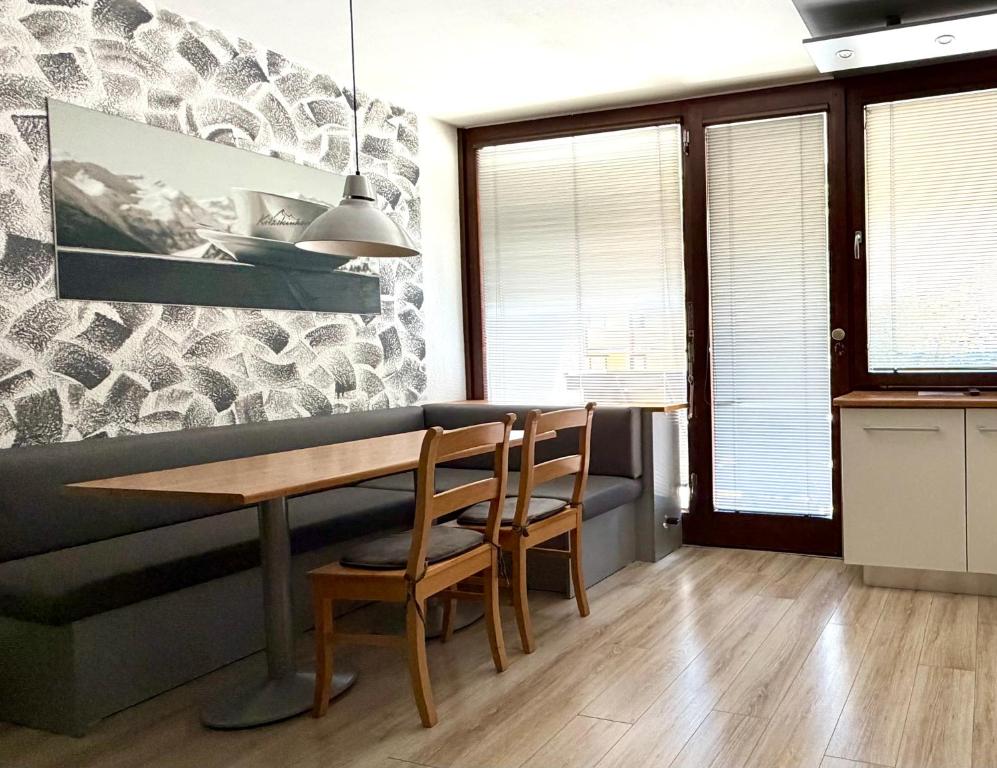 a dining room with a table and two chairs at Apartment Essreithweg Kaprun by Jara in Kaprun