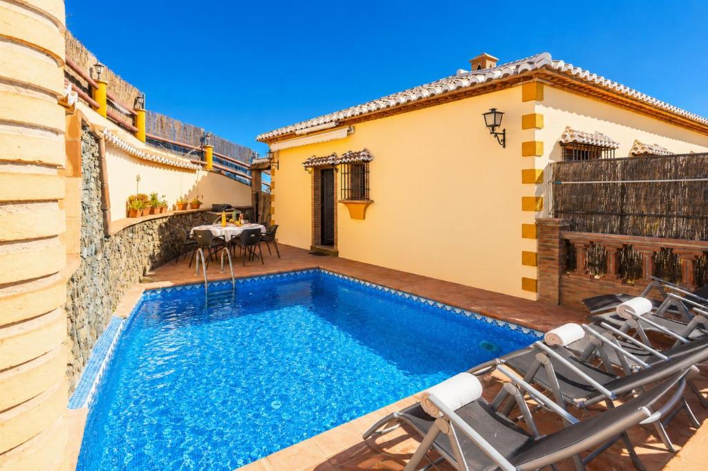 a villa with a swimming pool and a patio at Villa Las Palomas 2 in Nerja