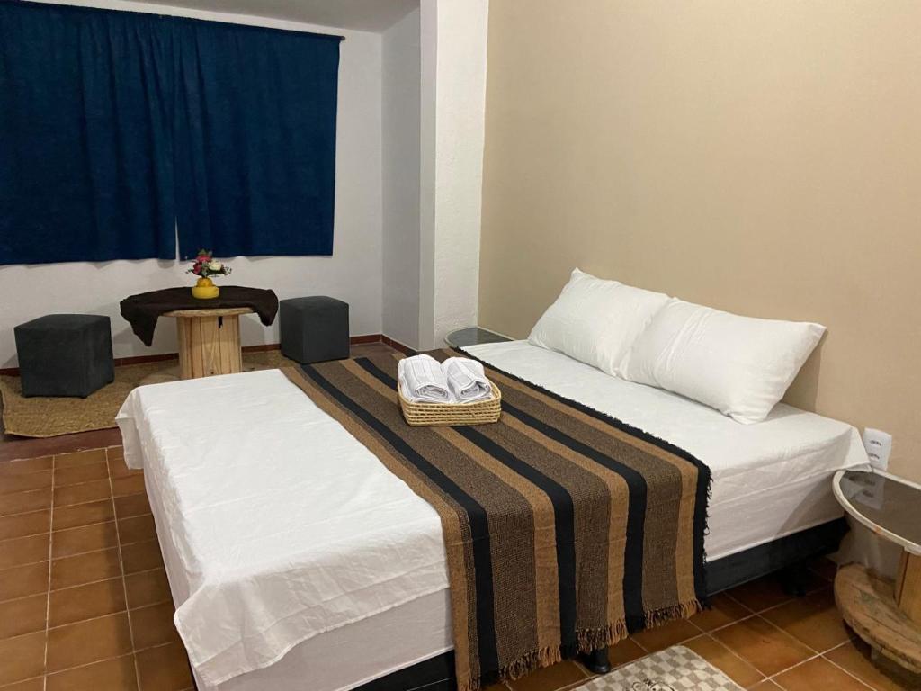 a hotel room with two beds with towels on them at Pousada Nosso Sonho in Natal