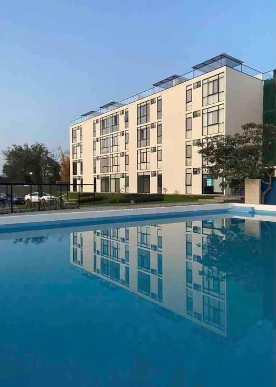 an empty swimming pool in front of a building at Relax at the lake - Pool - Pet friendly - WiFi in Chantepec