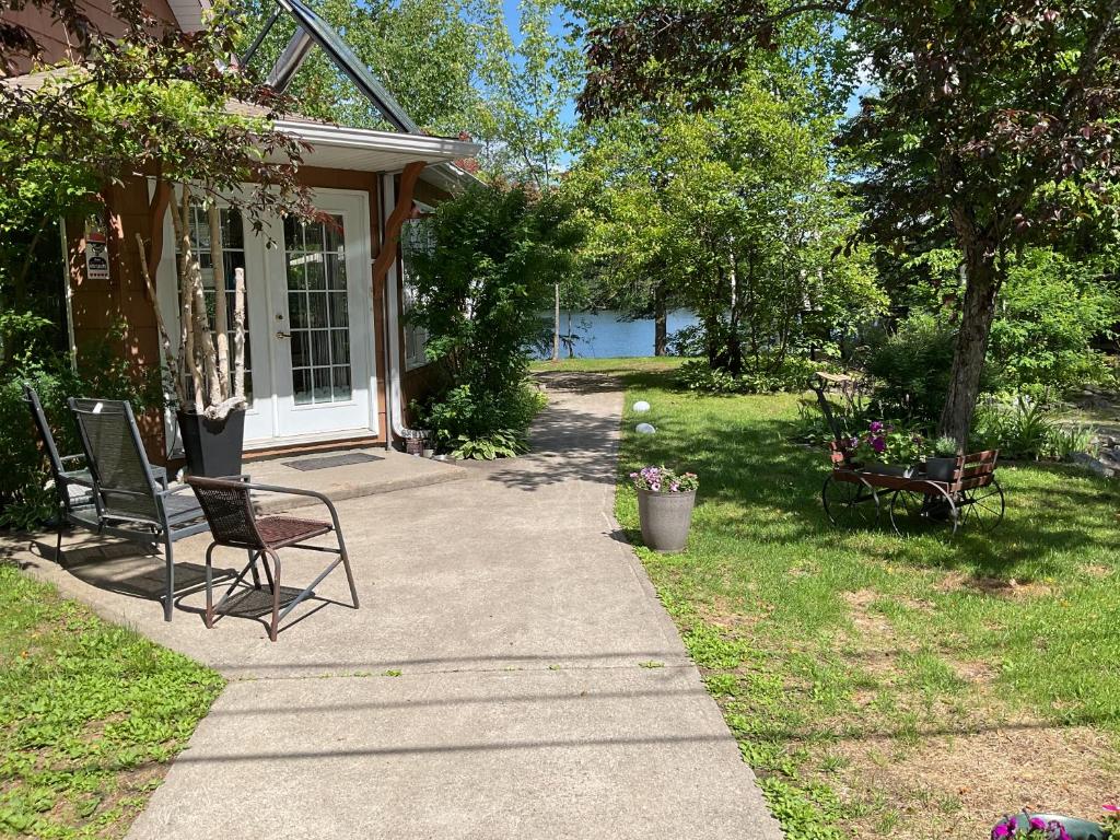 two chairs sitting on a porch of a house at Gite du Lac Docteur in Saint-Honoré