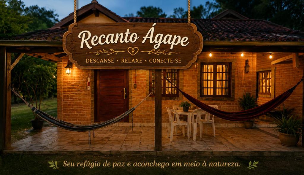 a sign in front of a house with a restaurant envelope at Recanto agape chalés e cabana in Rosas