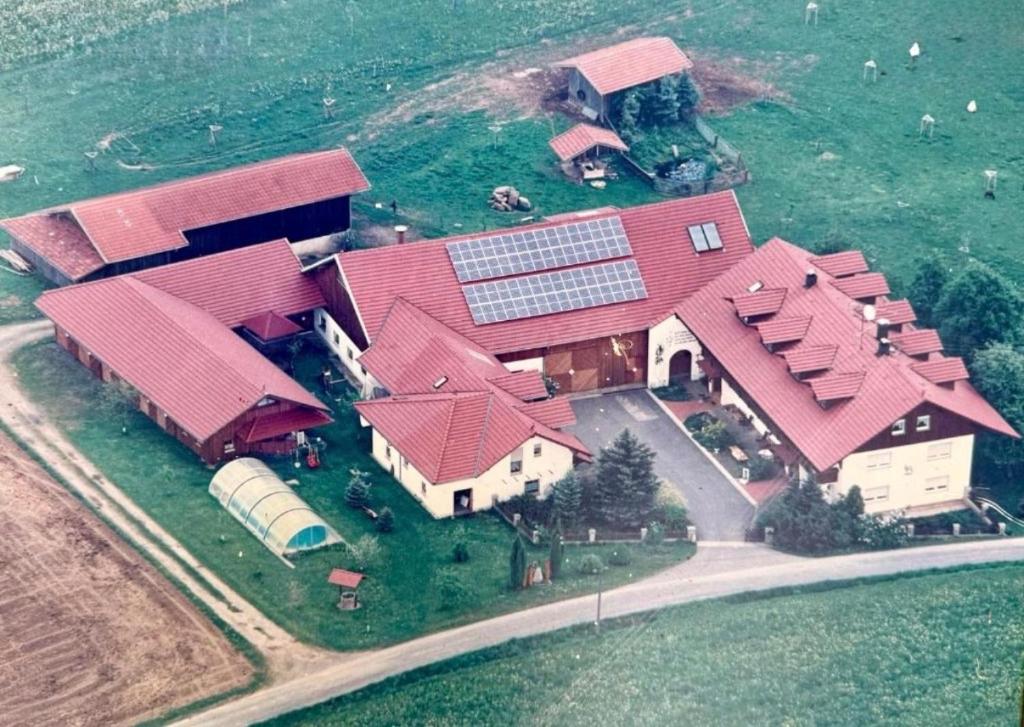 an aerial view of a large house with red roofs at Haus Franz in Zandt