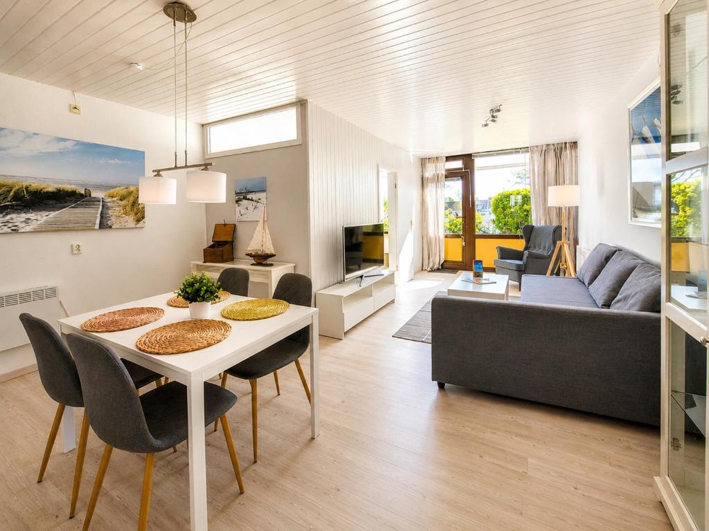 a living room with a table and a couch at Strandläufer in Wendtorf