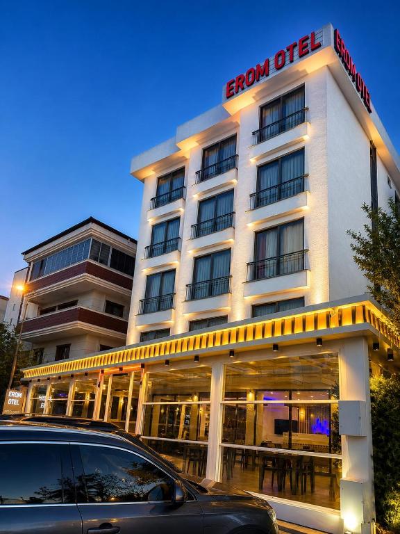 a hotel with a car parked in front of it at Erom Otel in Trabzon