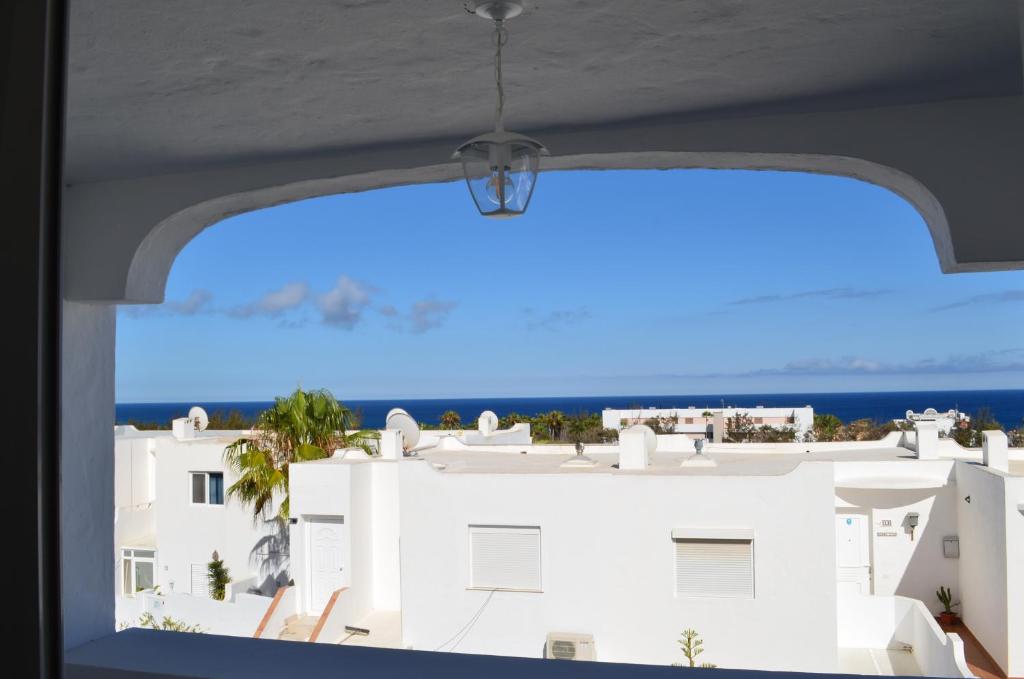 a window with a view of a white building at Montaña Tirba in Costa Calma