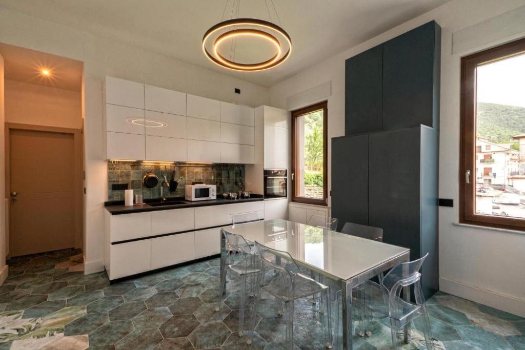 a kitchen with a glass table in a room at Ca'santoro 3 in Agerola