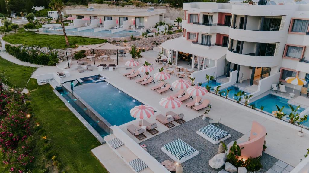 an aerial view of a resort with a swimming pool and chairs at The Palms Concept Hotel Adults Only 16 Plus in Faliraki