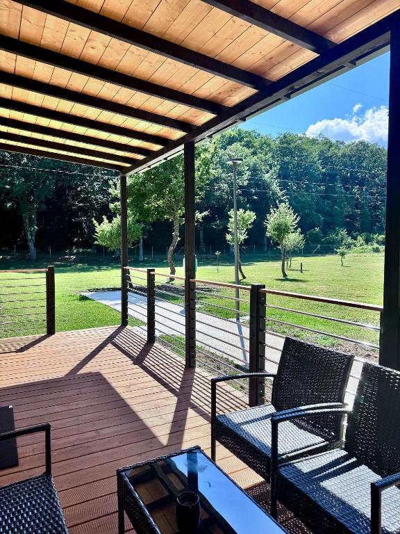 a deck with chairs and a table and a fence at Chalet - Snow Village Roccaraso in Roccaraso
