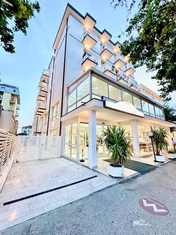 a large white building with a lot of windows at hotel Torretta Bramante in Rimini