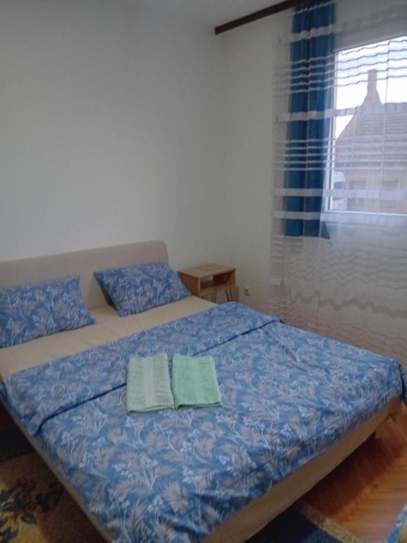 a bedroom with a bed with two towels on it at Smestaj Prokuplje in Prokuplje