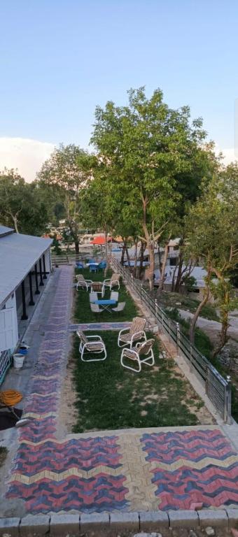 a park with chairs and tables on the grass at DREAM LAND cottage in Abbottabad