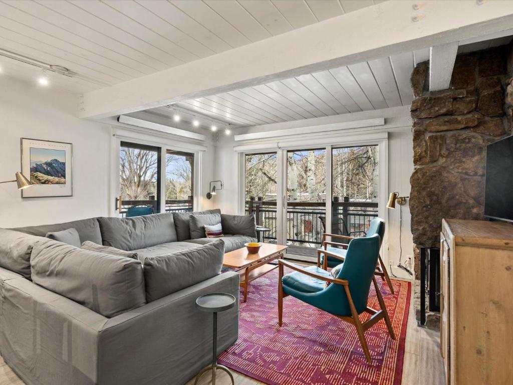 a living room with a couch and a table at Lift One Condominiums - Unit 305 in Aspen