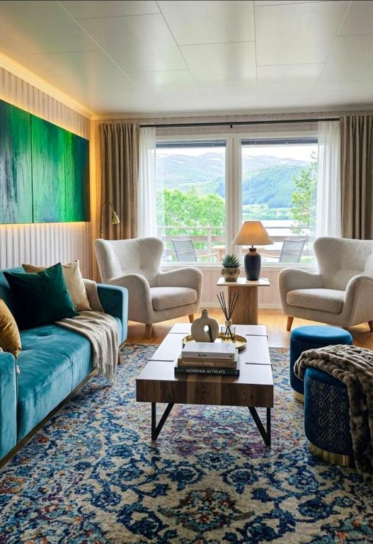 a living room with a blue couch and chairs at La Casa Senja in Håverjorda