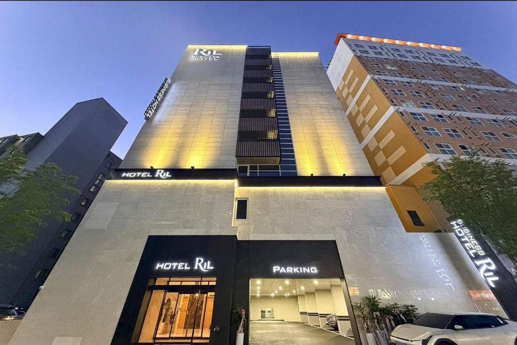 a tall building with a sign on the side of it at Hotel RIL in Gwangju