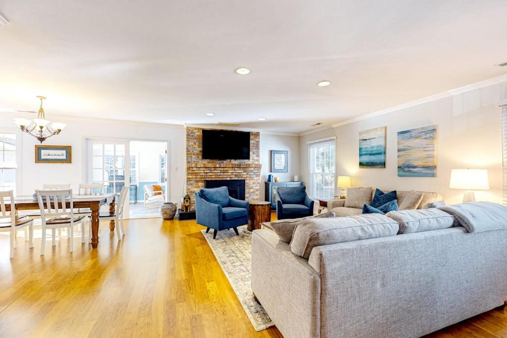 a living room with a couch and a dining room at The Nest in Ocean Pines