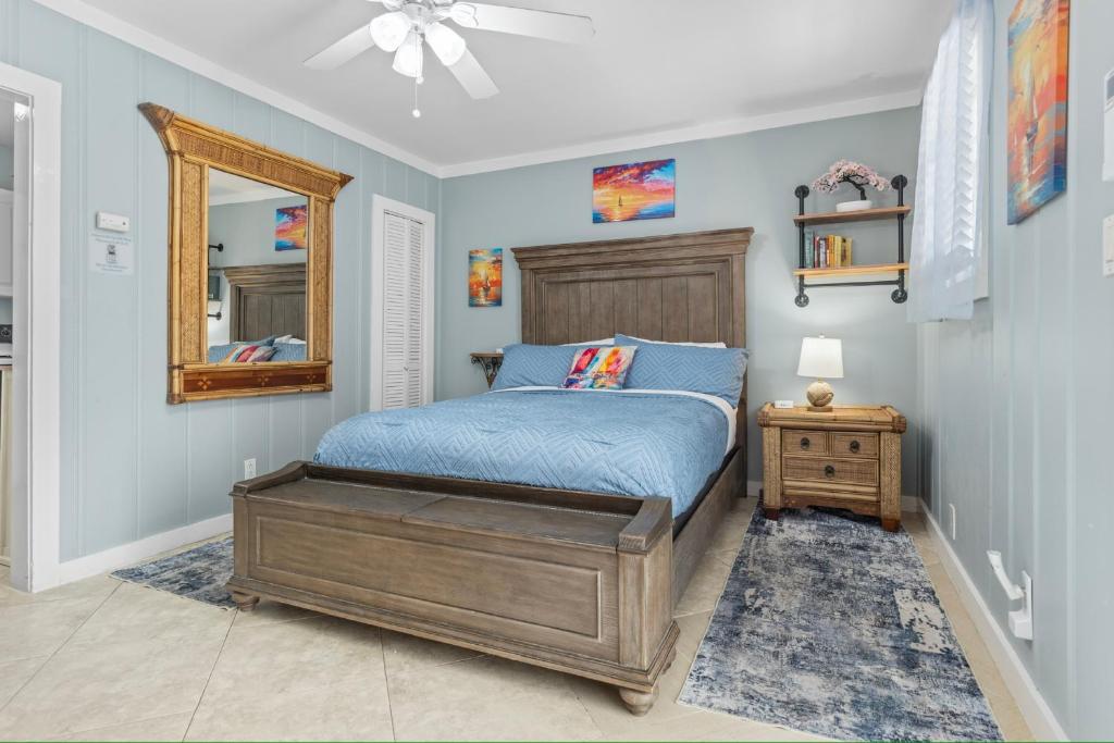 a bedroom with a bed and a mirror at Prime Downtown Location - Truman Little Cozy Cottage in Key West