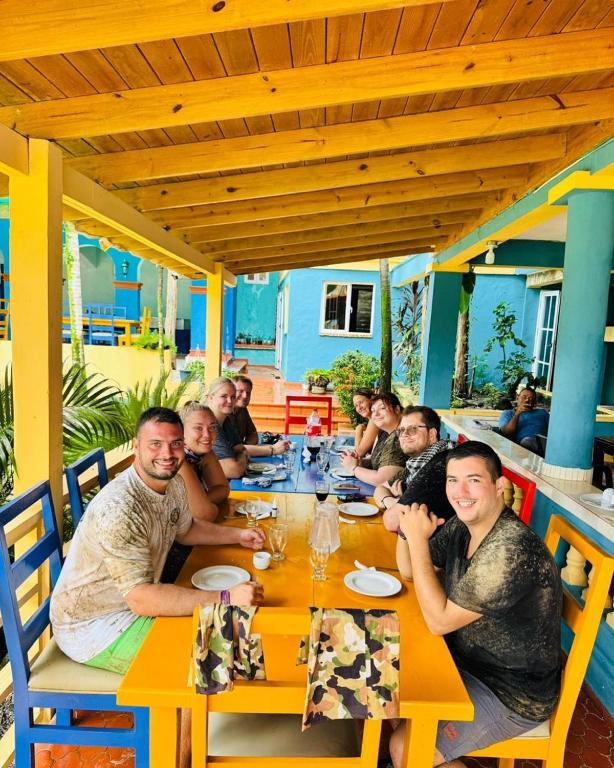 a group of people sitting at a table in a restaurant at Rancho La Cueva in Miches