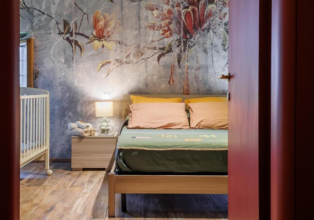 a bedroom with a bed and a painting on the wall at B&B Locanda Cistercense in San Martino al Cimino