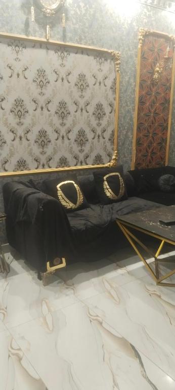 a couch in a room with a wall at Khokhar house in Lahore