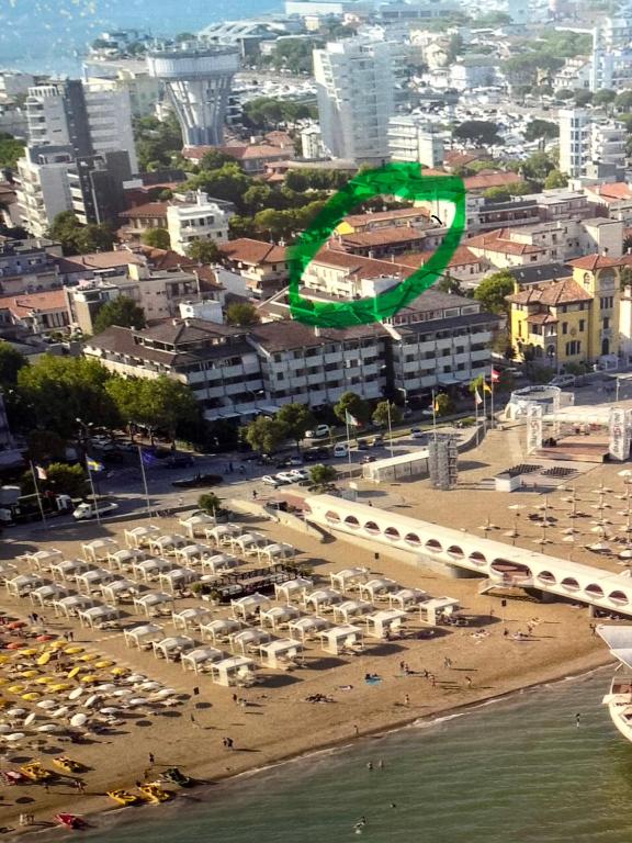 a beach with umbrellas and a crowd of people at Open space centre in Lignano Sabbiadoro
